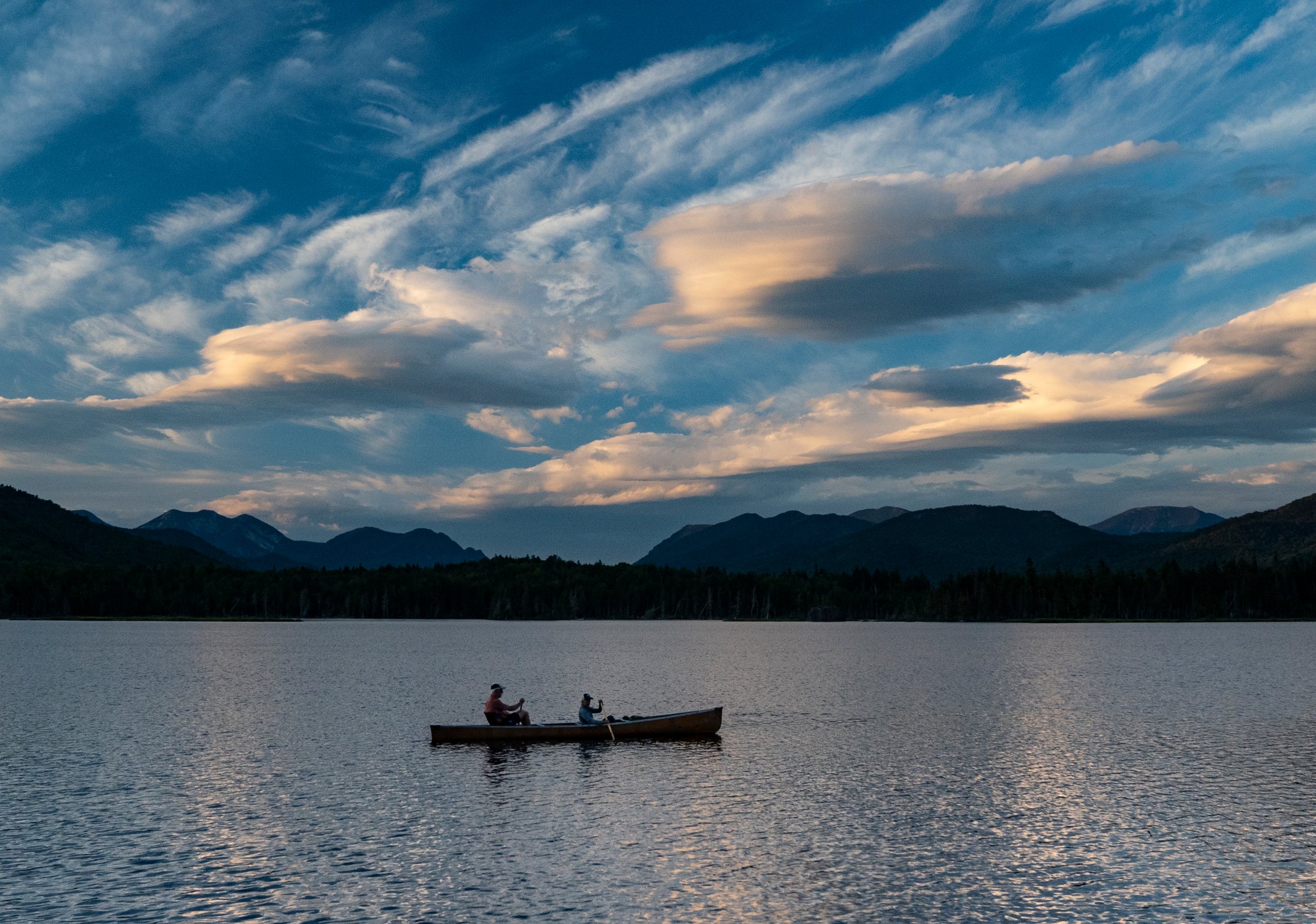 Two people in a canoe on serene water